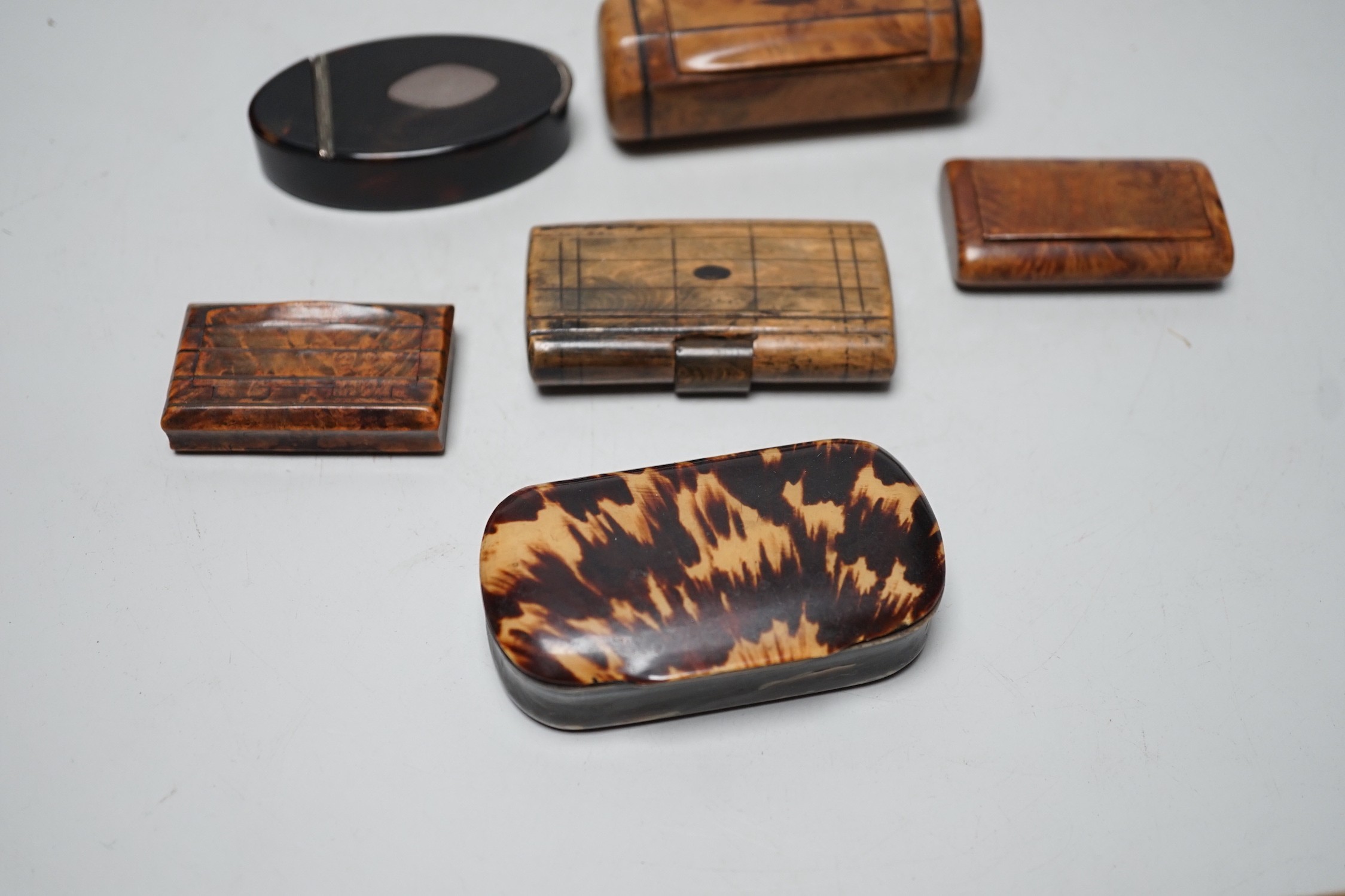 Two 19th century tortoiseshell snuff boxes and four treen snuff boxes.